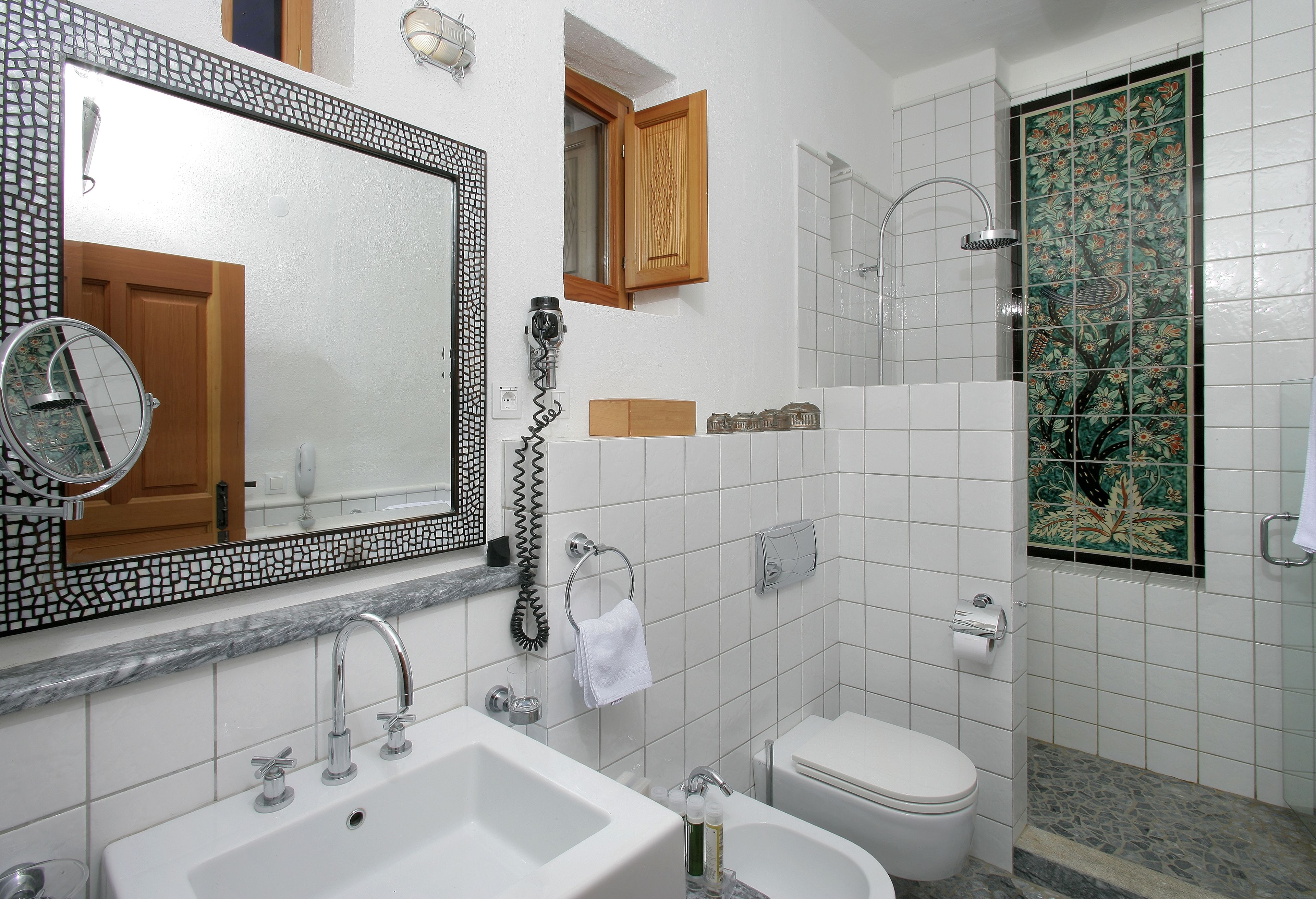 A bathroom with a sink, toilet, and shower.