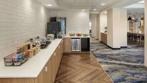 A modern kitchen with a long counter, a refrigerator, and a microwave. - Fairfield Inn & Suites by Marriott Clovis (Clovis)
