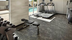 A gym with treadmills, dumbbells, and a bench. - Fairfield Inn & Suites by Marriott Clovis (Clovis)