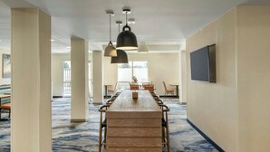 A conference room with a long table, chairs, and pendant lighting. - Fairfield Inn & Suites by Marriott Clovis (Clovis)