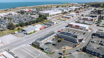 An aerial view of a commercial area with multiple buildings, roads, and parking lots.