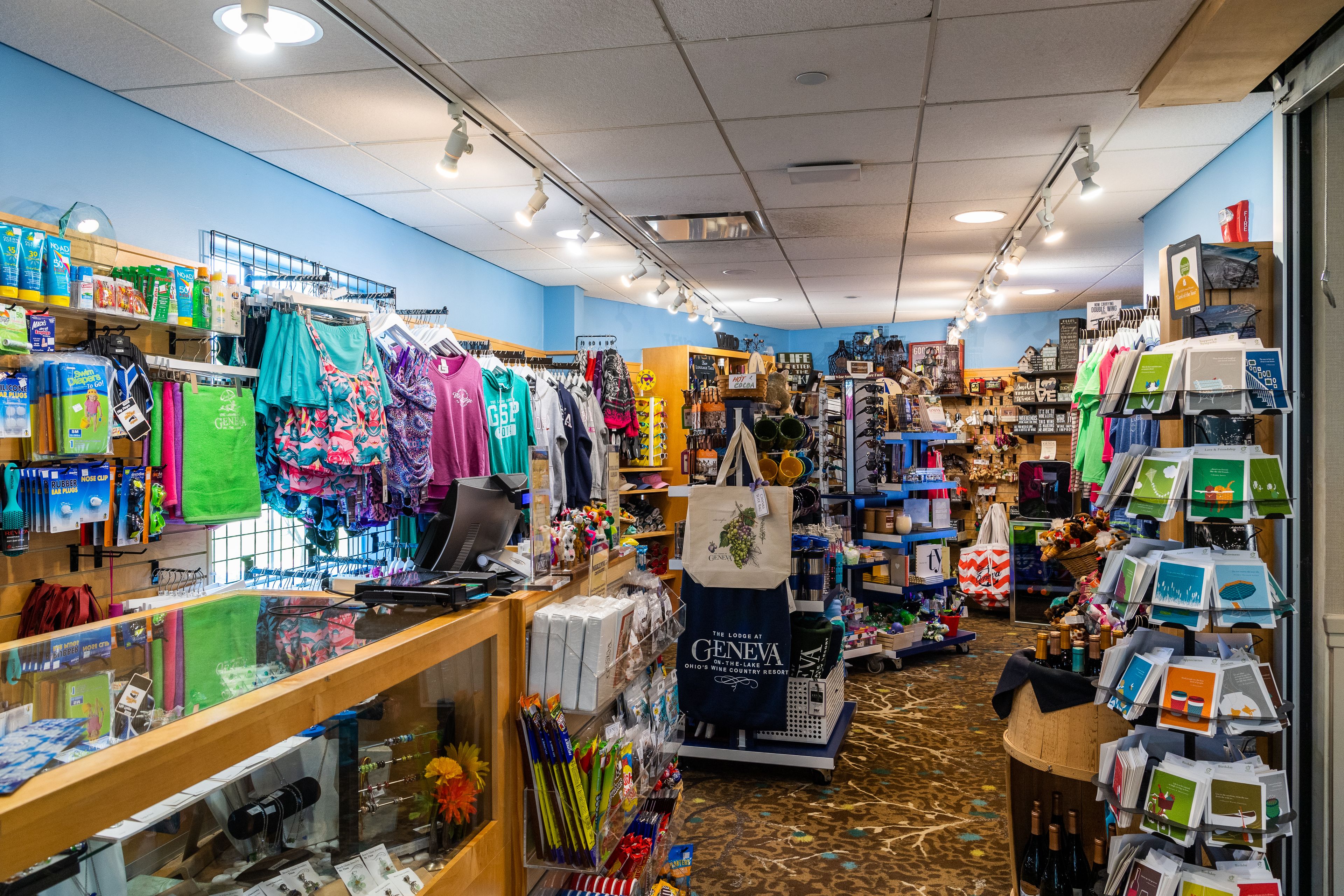 A well-lit store with various items on display, including clothing and accessories.