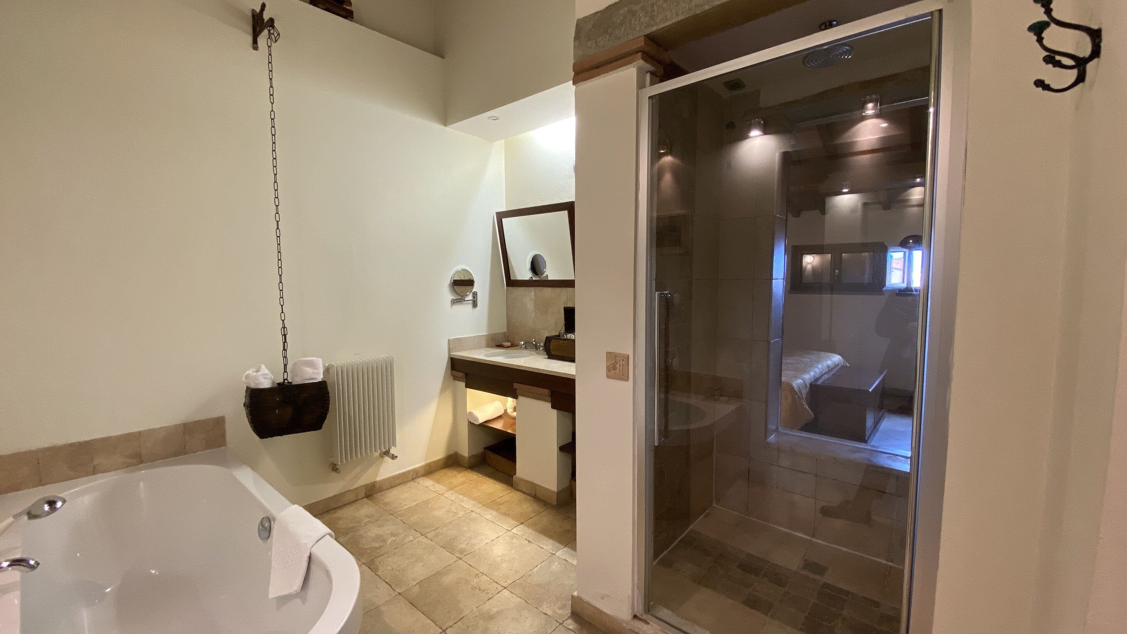 A bathroom with a bathtub, a shower, and a sink.