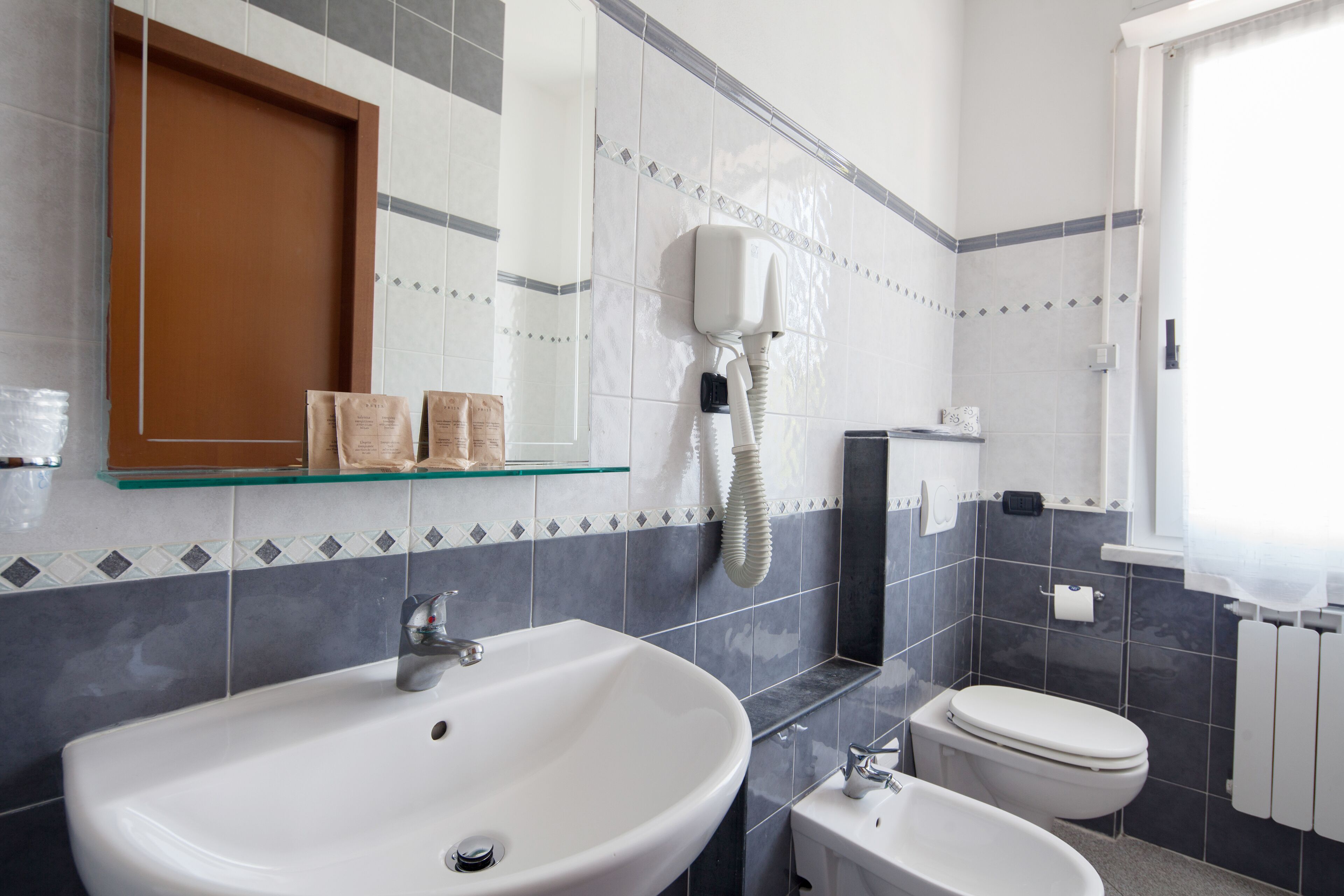 standard triple room | bathroom | shower, hair dryer, slippers, towels