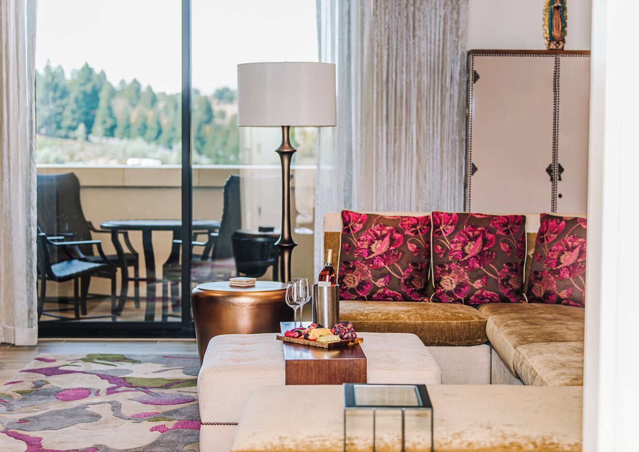 A modern living room with a sofa, a coffee table, and a dining area with chairs and a table.