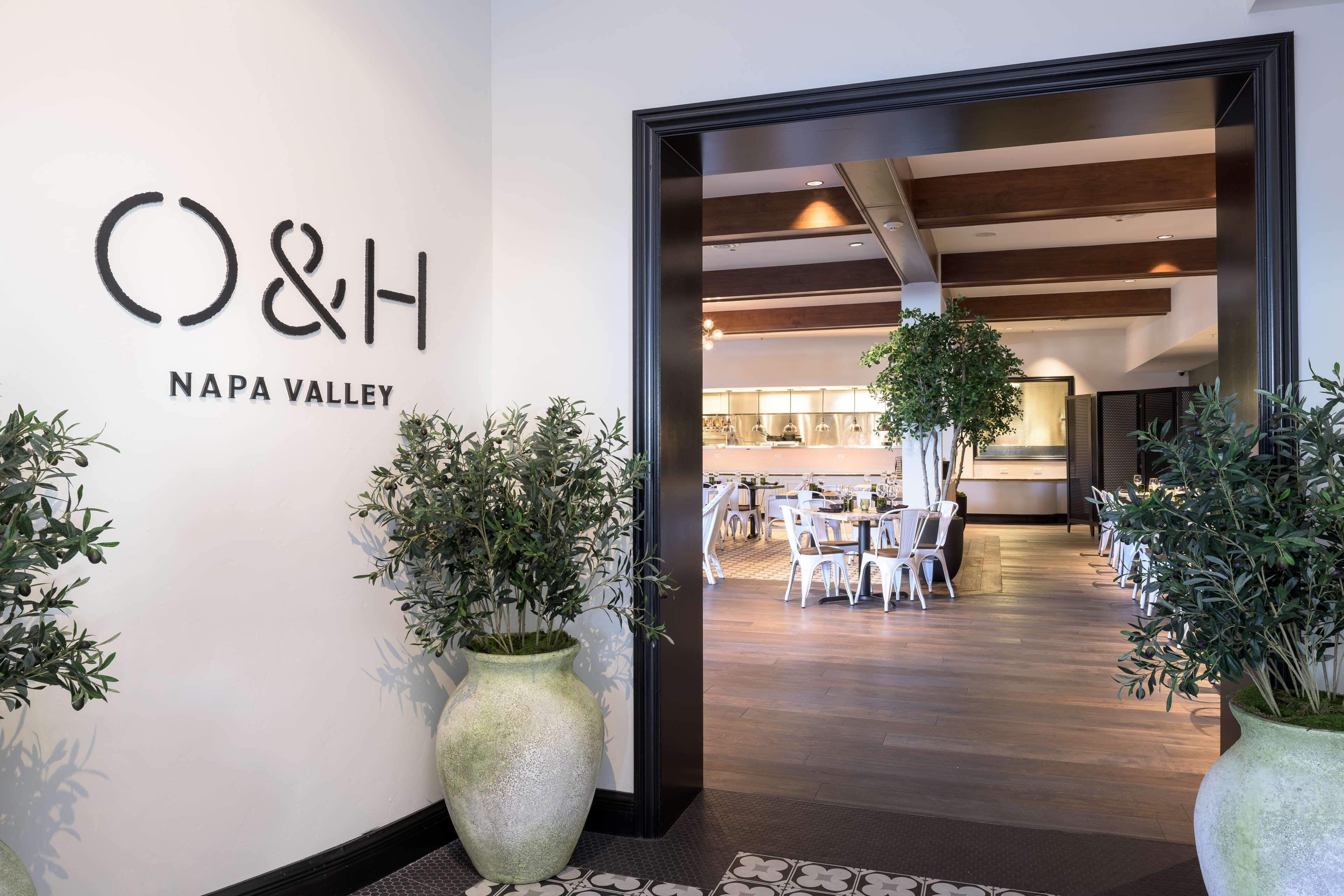 A hotel entrance with a sign reading "O&H Napa Valley".