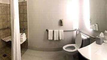 A bathroom with a shower, toilet, and sink.