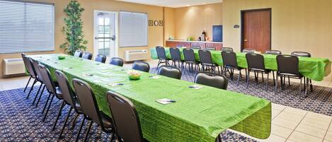 A conference room with a long table, chairs, and a 'STAFF ONLY' sign.