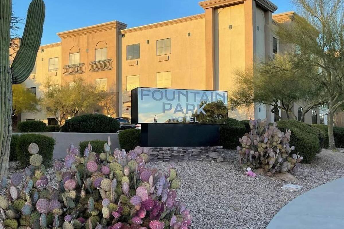 A building with a sign reading 'Fountain Park Hotel.'