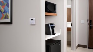 A modern kitchen with a microwave, coffee maker, and refrigerator on a white shelf. - Holiday Inn Express Knoxville-Strawberry Plains by IHG (Knoxville)