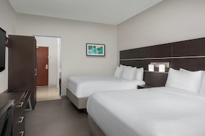 A hotel room with two beds, a desk, a TV, and a framed picture on the wall. - Holiday Inn Express Knoxville-Strawberry Plains by IHG (Knoxville)