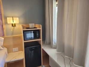 Desk, laptop workspace, blackout drapes, iron/ironing board
