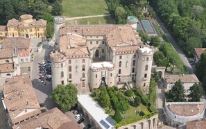 A large, historic building with multiple towers and a central courtyard.
