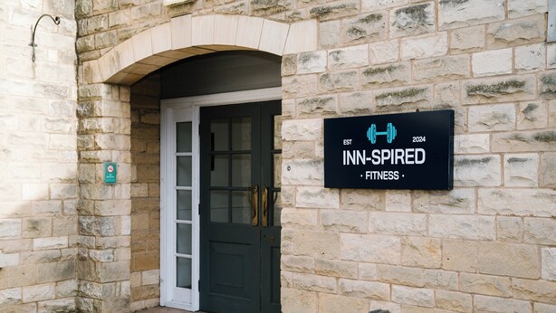 A stone building with a sign that reads "INN-INSPIRED FITNESS" and a door. - Holiday Inn Doncaster A1 M Jct 36 by IHG (Doncaster)