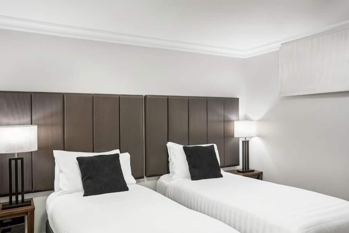 Premium bedding, desk, laptop workspace, iron/ironing board
