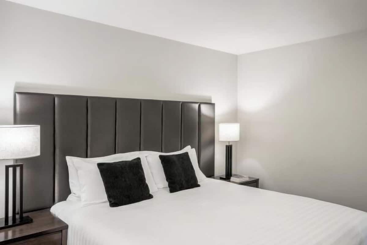 Premium bedding, desk, laptop workspace, iron/ironing board
