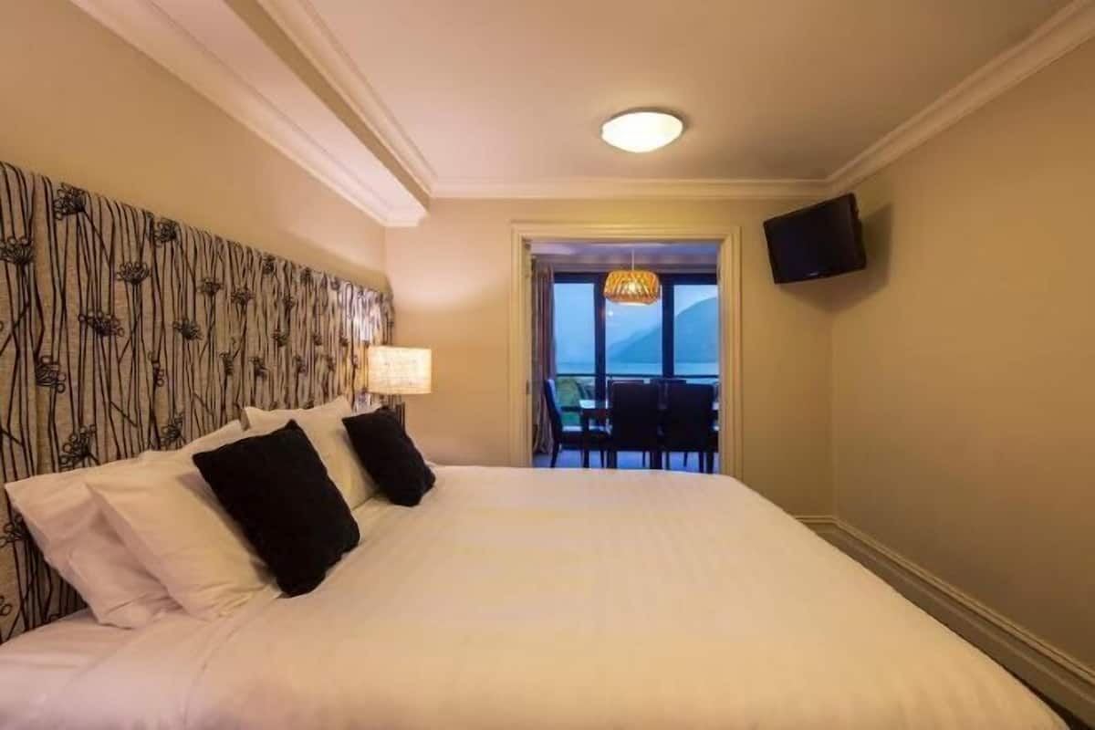 Premium bedding, desk, laptop workspace, iron/ironing board