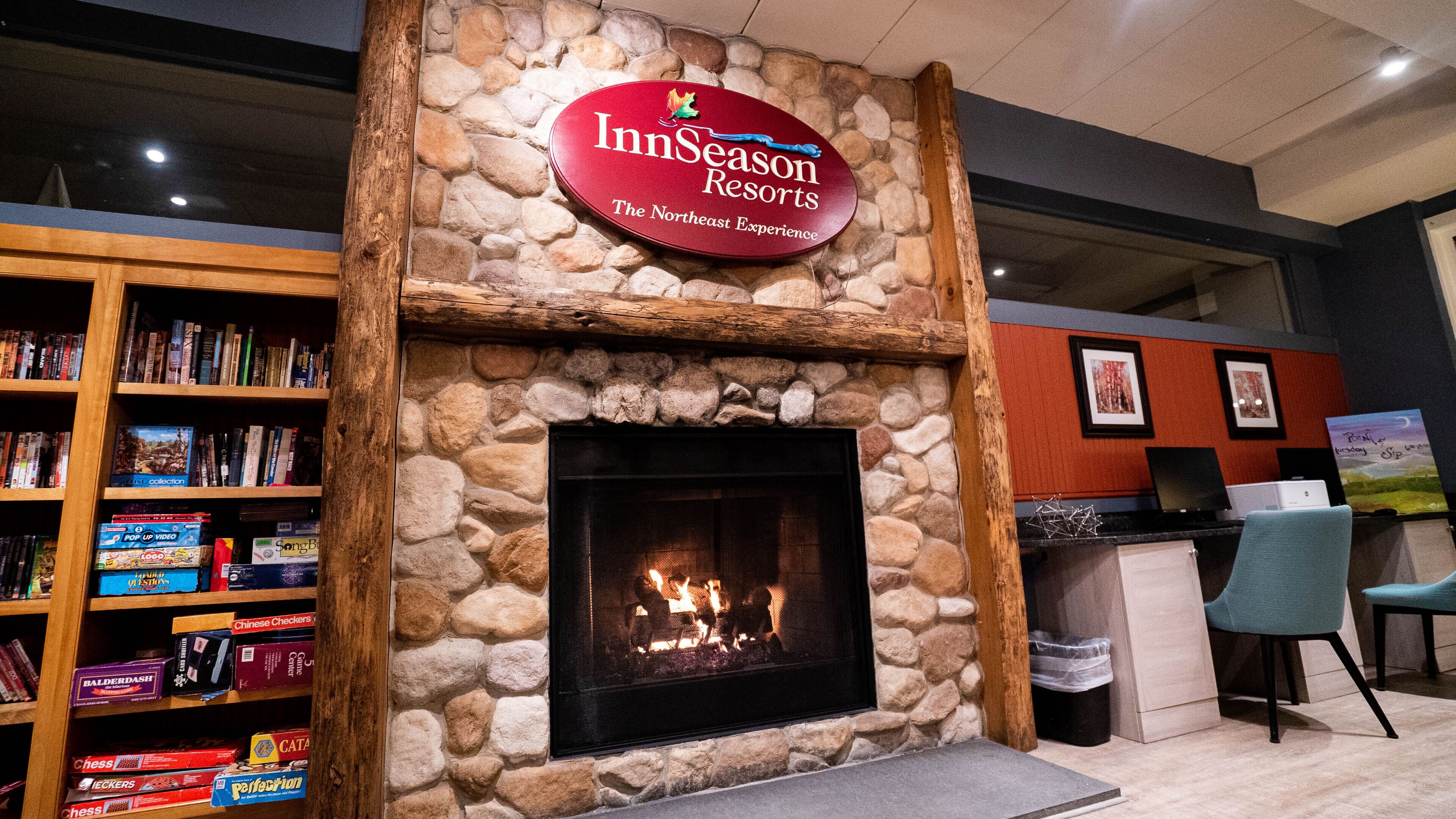 A stone fireplace with a sign above it reading "InnSeason Resorts The Northeast Experience".