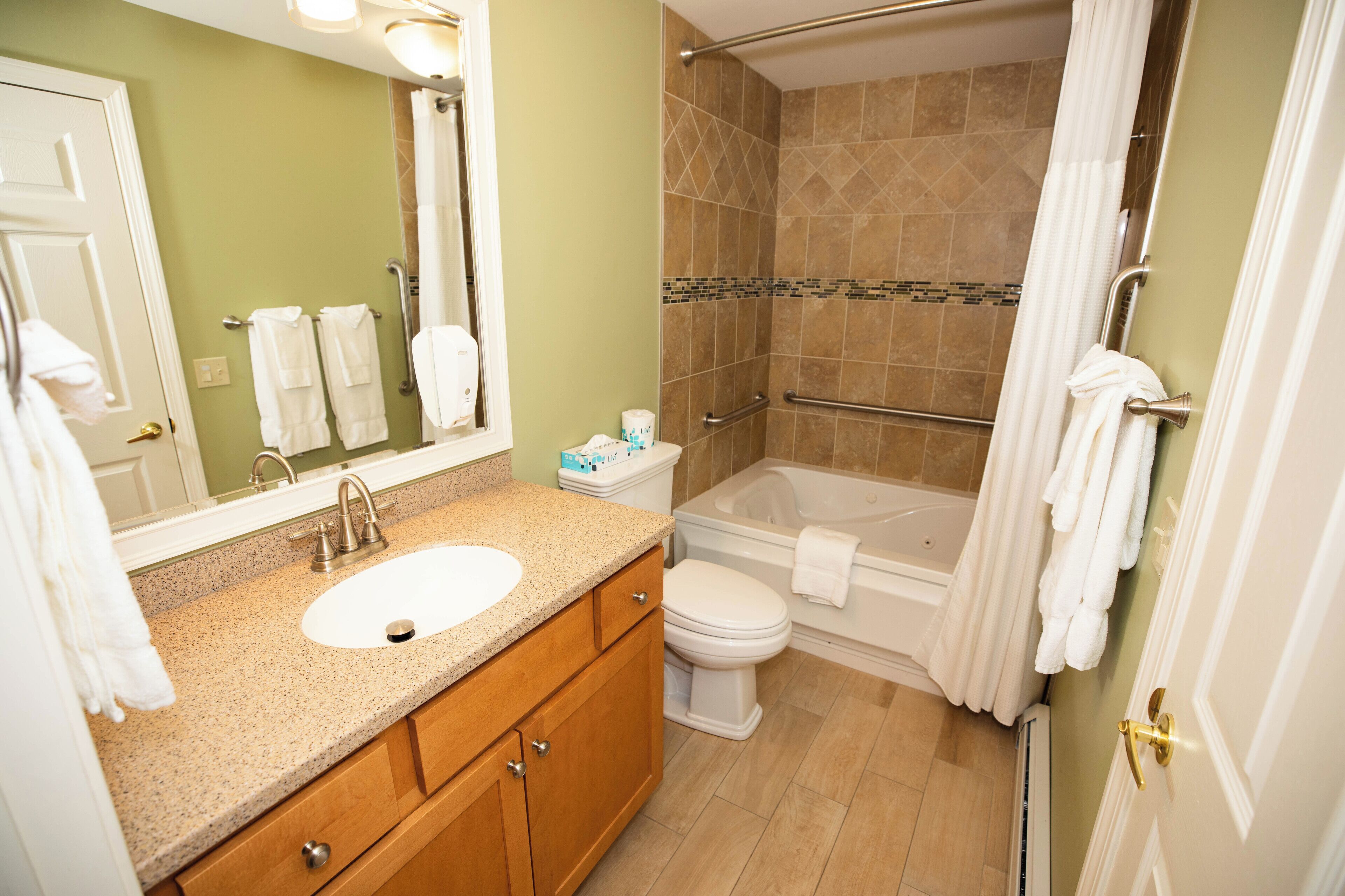 A bathroom with a sink, toilet, bathtub, and shower.