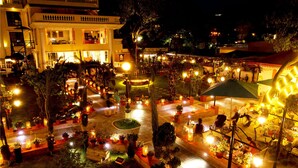 A courtyard with outdoor seating, potted plants, and a fountain. - Kathmandu Guest House by KGH Group (Kathmandu)