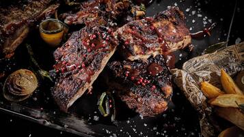 A steak with red peppercorns and a side of fries.
