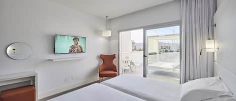A hotel room with two beds, a TV on the wall, a chair, and a balcony with a view.