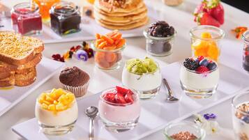 A variety of desserts and pastries on a white table.