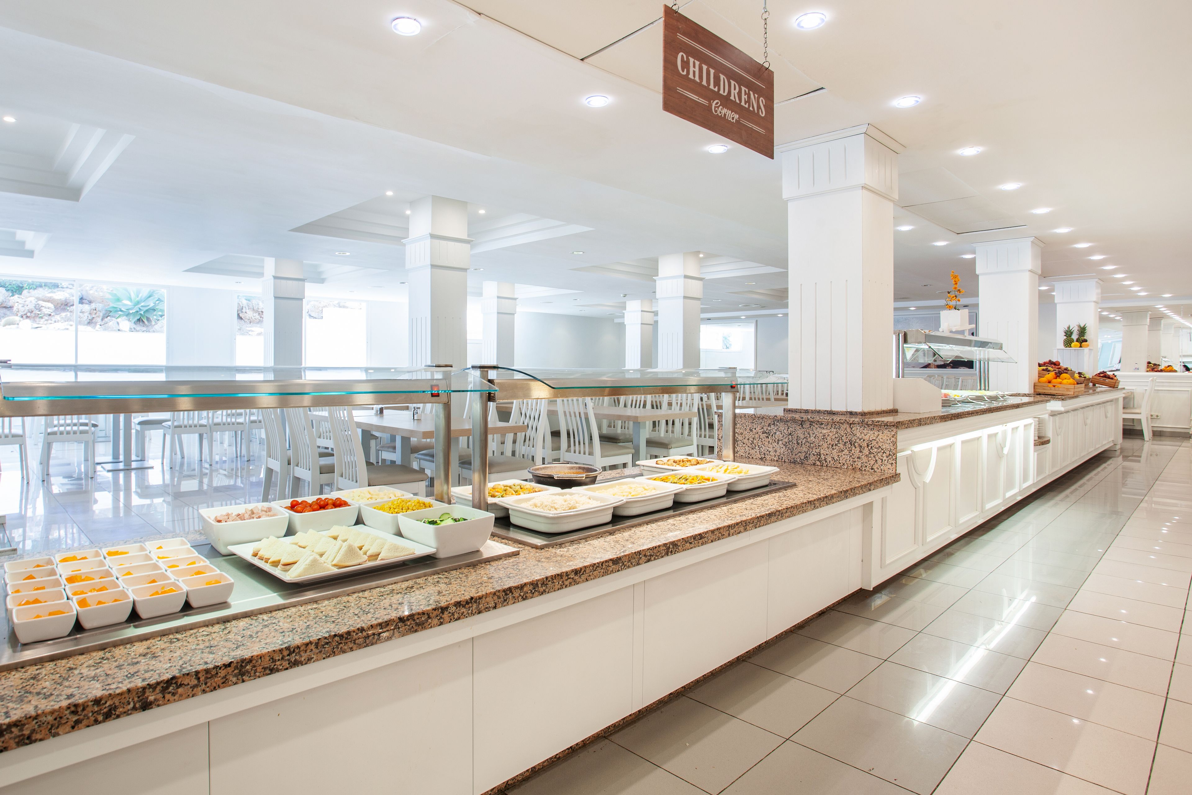 A buffet area with various food options and a sign indicating it is the Childrens Center.
