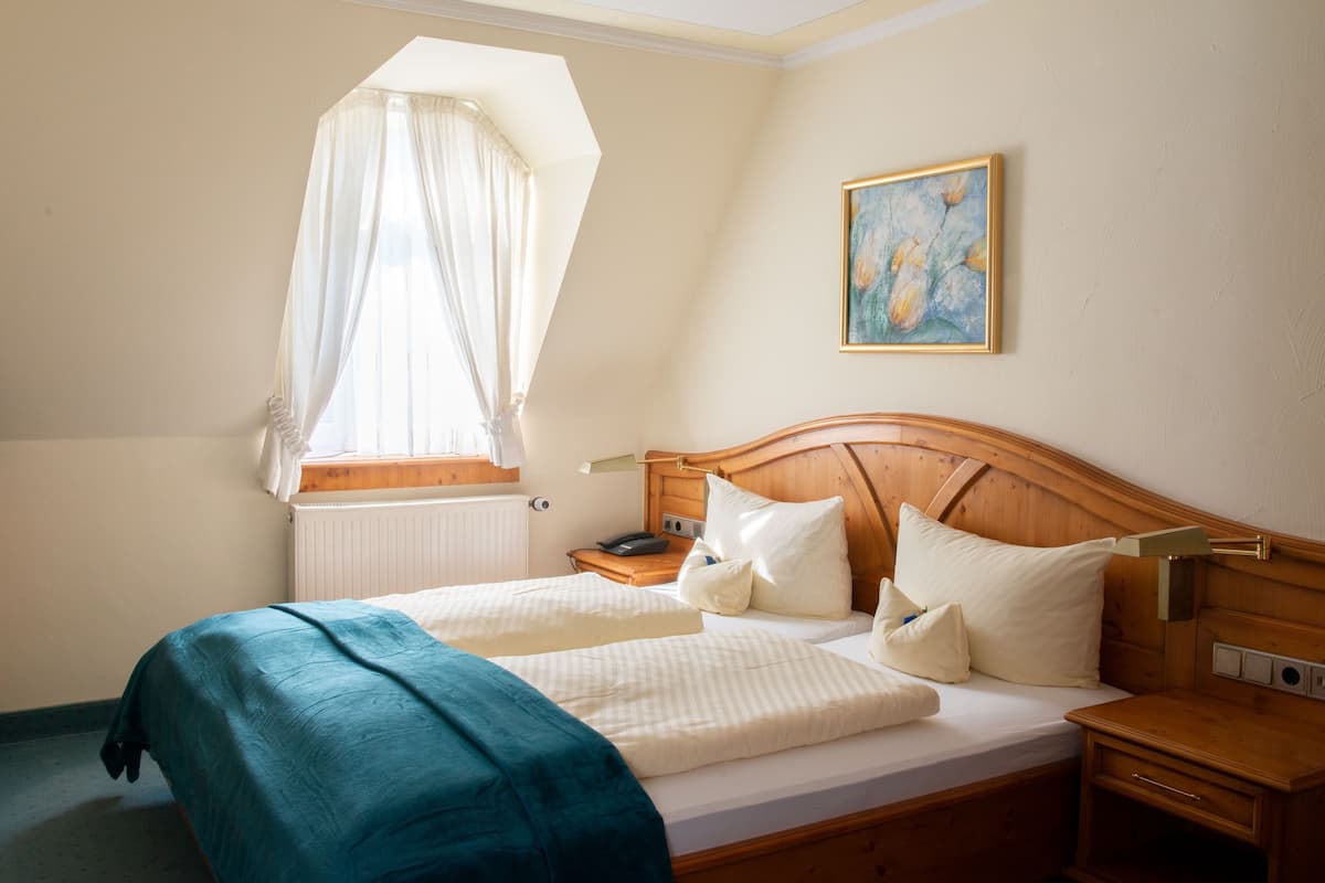Comfort Triple Room | Minibar, in-room safe, desk, blackout drapes