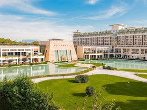 A hotel with multiple swimming pools, a well-maintained lawn, and a large building with a modern design. - Rixos Premium Belek - The Land of Legends Access (Serik)