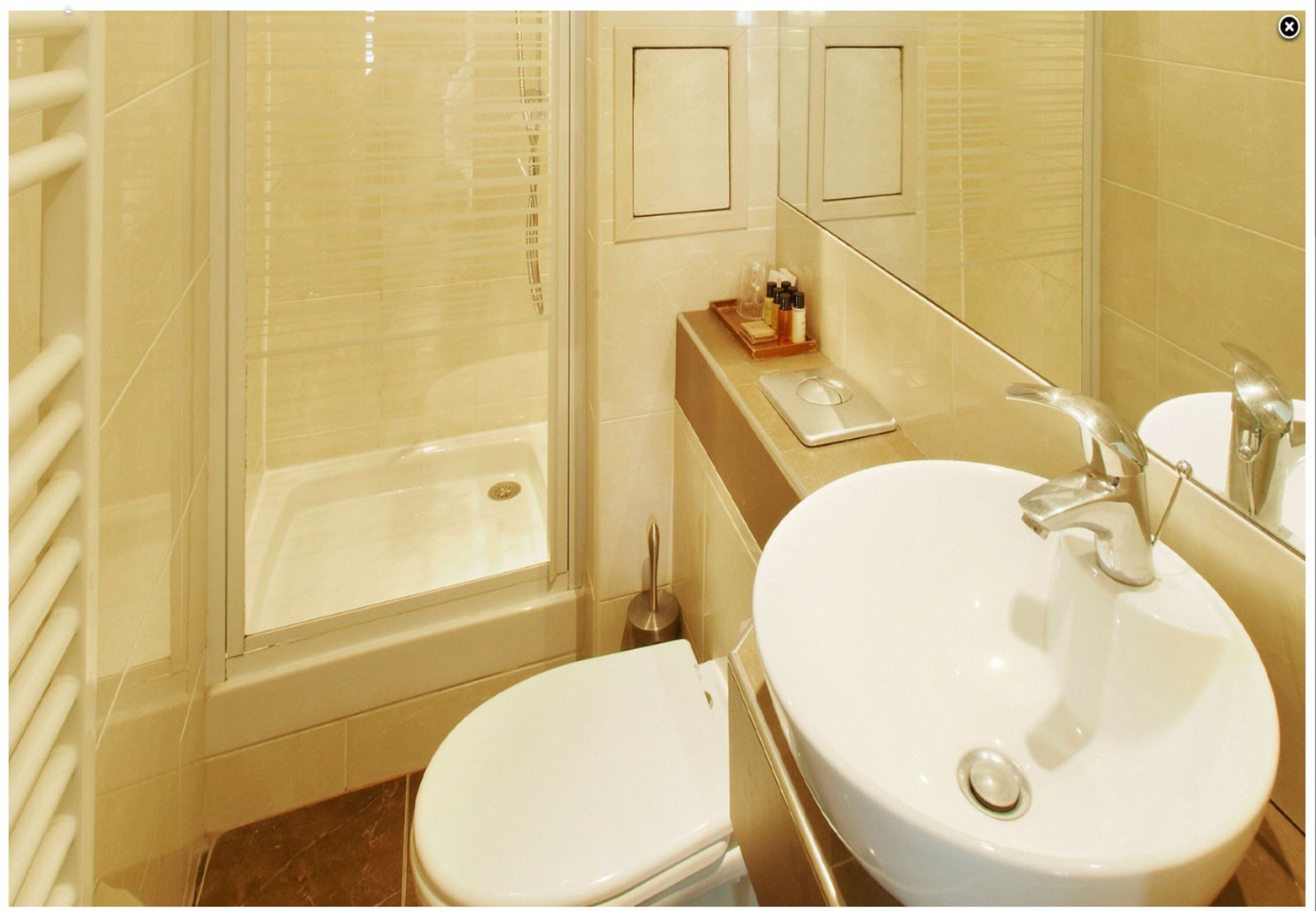 A bathroom with a bathtub, toilet, and sink.