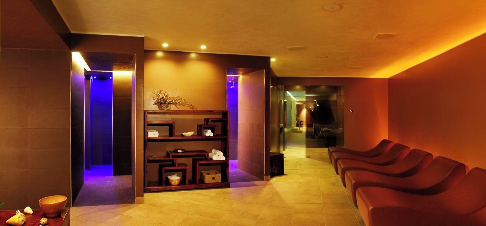 A spa area with a reception desk, a reception area, and a row of massage chairs.