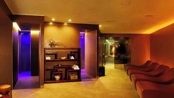A spa area with a reception desk, a reception area, and a row of massage chairs.