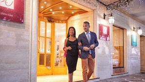 A hotel entrance with a wooden facade, a glass door, and a sign indicating 'place hotel.' - Ambasciatori Place Hotel (Fiuggi)