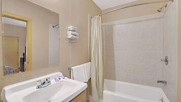 Badkamer | Een bad/douchecombinatie, gratis toiletartikelen, handdoeken