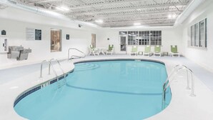 An indoor swimming pool with a clear depth marking of 4 feet 6 inches.