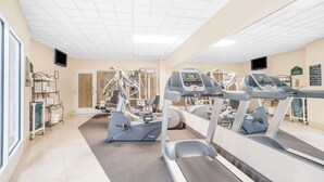 A gym with treadmills, elliptical machines, and weight equipment.