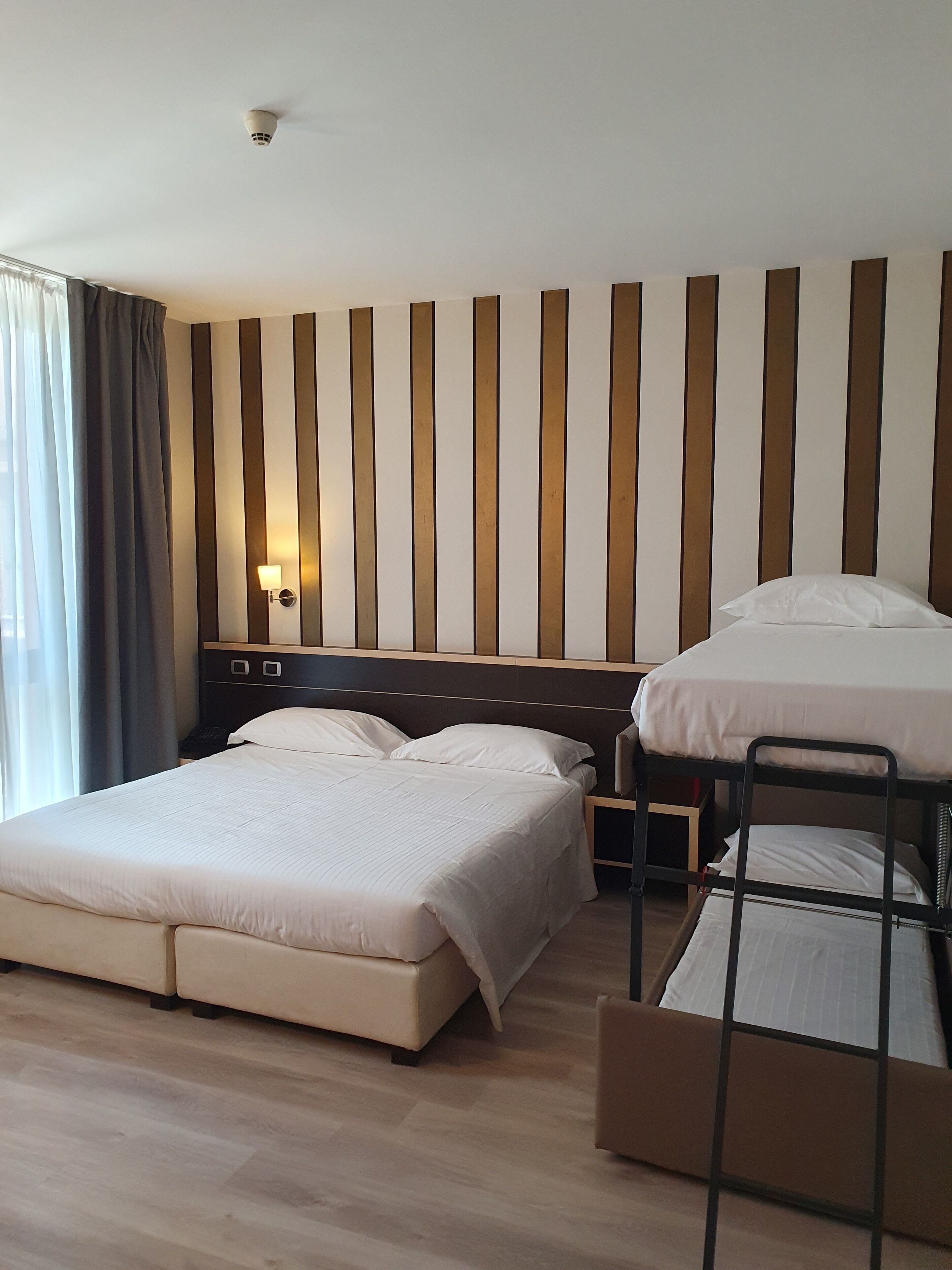 deluxe quadruple room | 1 bedroom, down duvets, minibar, in-room safe