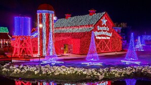 A building with a red facade and illuminated Christmas decorations, including a sign reading "Santa's Wonderland."