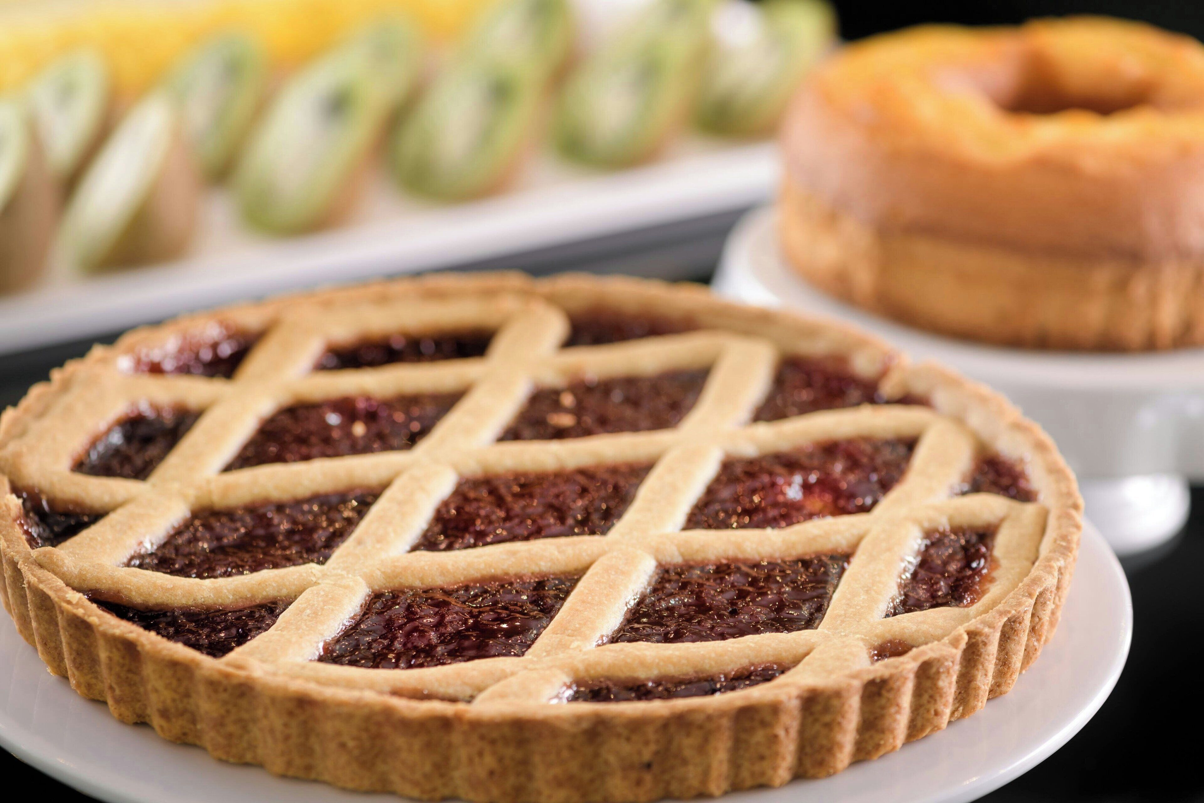A pie with a lattice crust on a plate.
