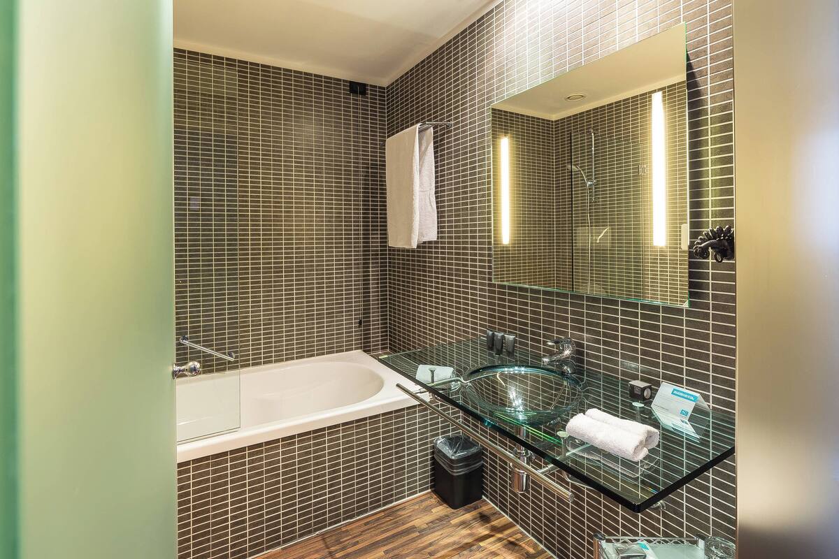 combined shower/bathtub, deep-soaking bathtub, designer toiletries