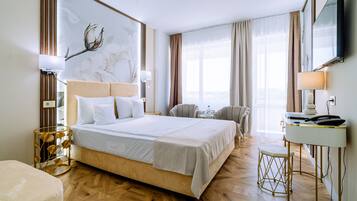 Deluxe Double Room, River View | Minibar, in-room safe, desk, laptop workspace