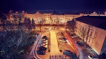 A parking lot with multiple cars and a building in the background.