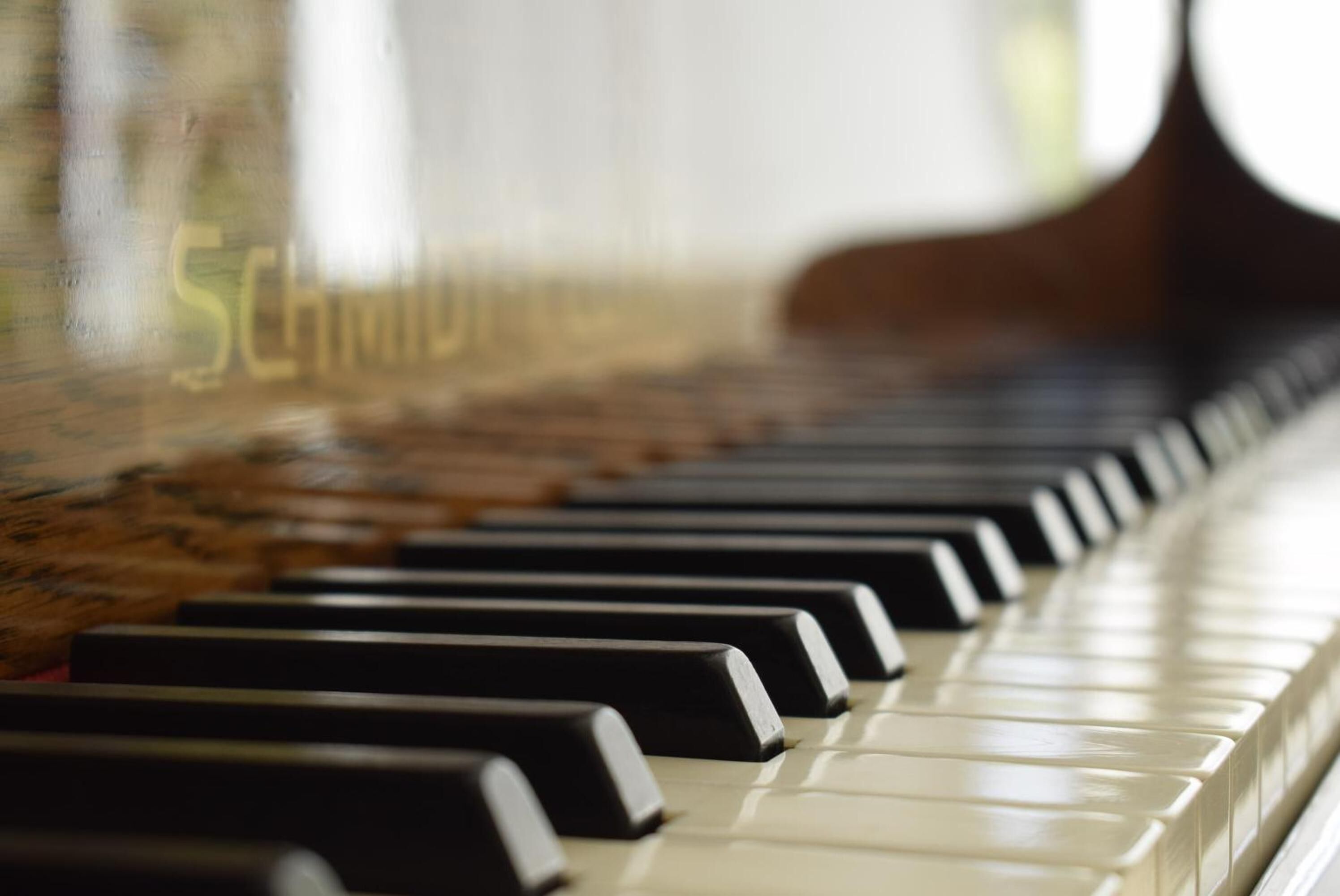 A close-up of a piano keyboard with black and white keys.