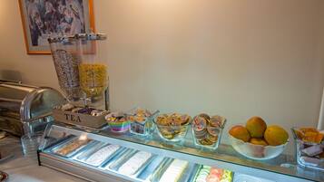 A buffet with various food items and a tea station.