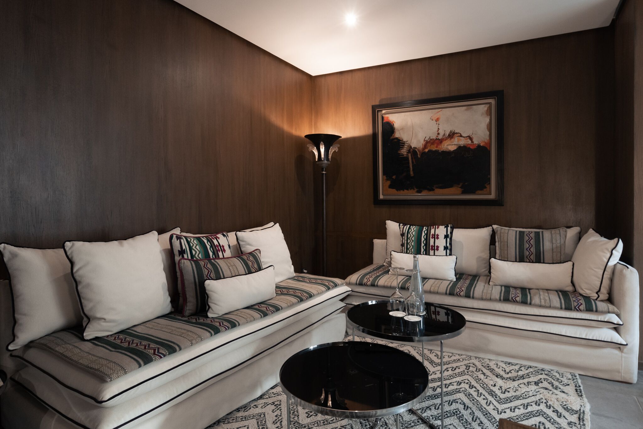 A living room with two sofas, a coffee table, and a floor lamp.