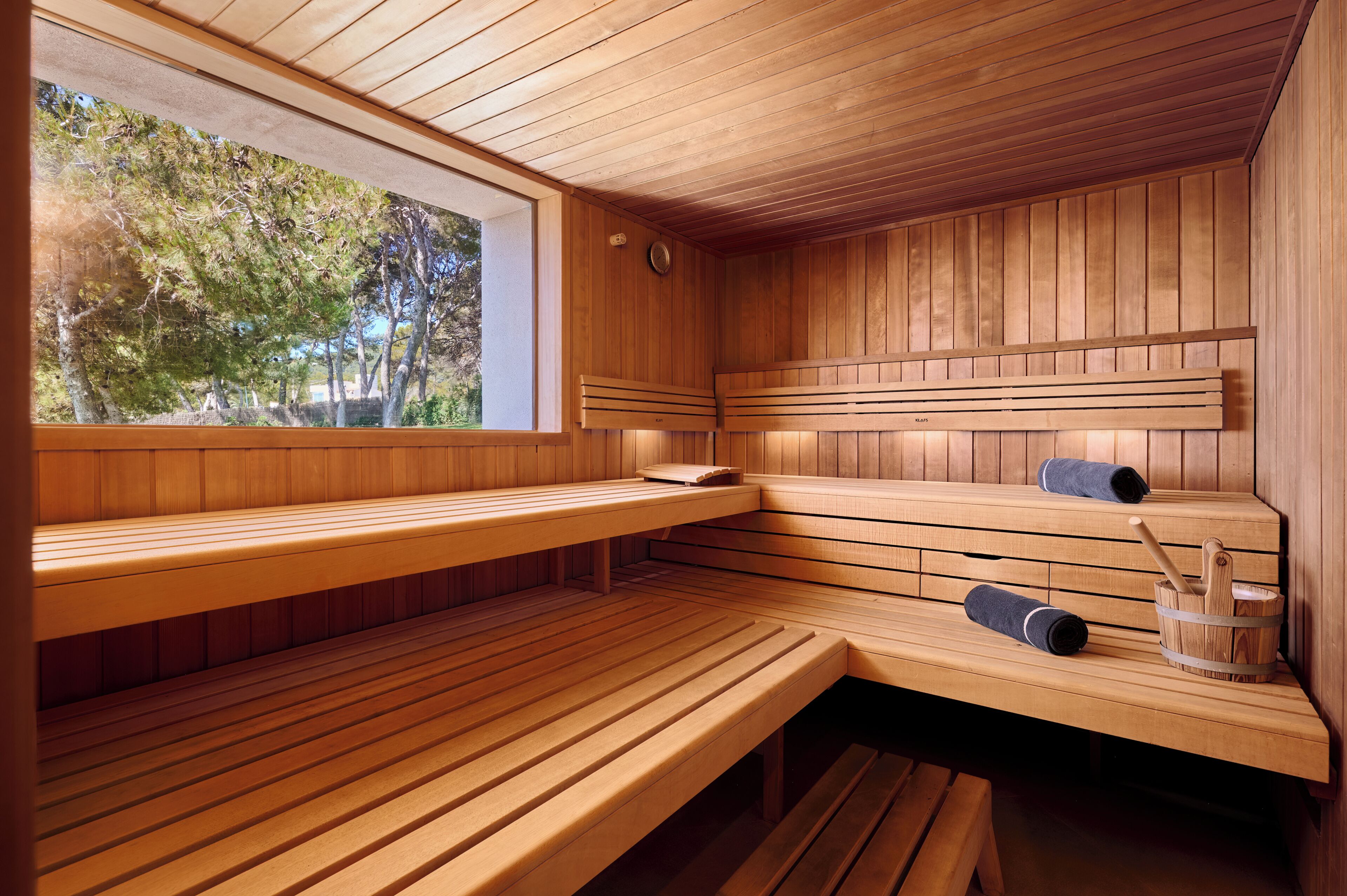 A sauna with wooden benches and a window.