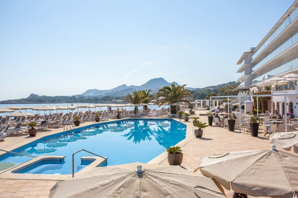 Alberca techada, alberca al aire libre y camastros