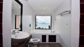 Separate bathtub and shower, towels