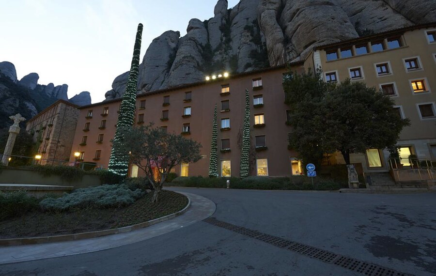 Hotel Abat Cisneros at Montserrat with the mountain cliffs behind the building